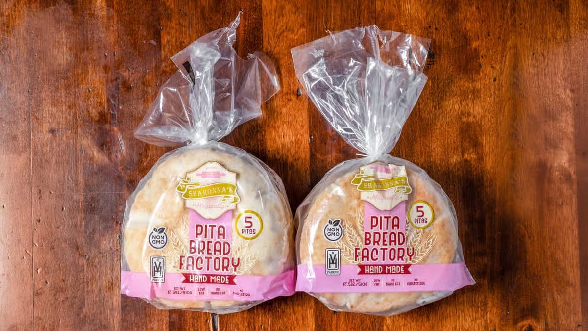 Two bags of Sharonna's handmade pita on a wooden table