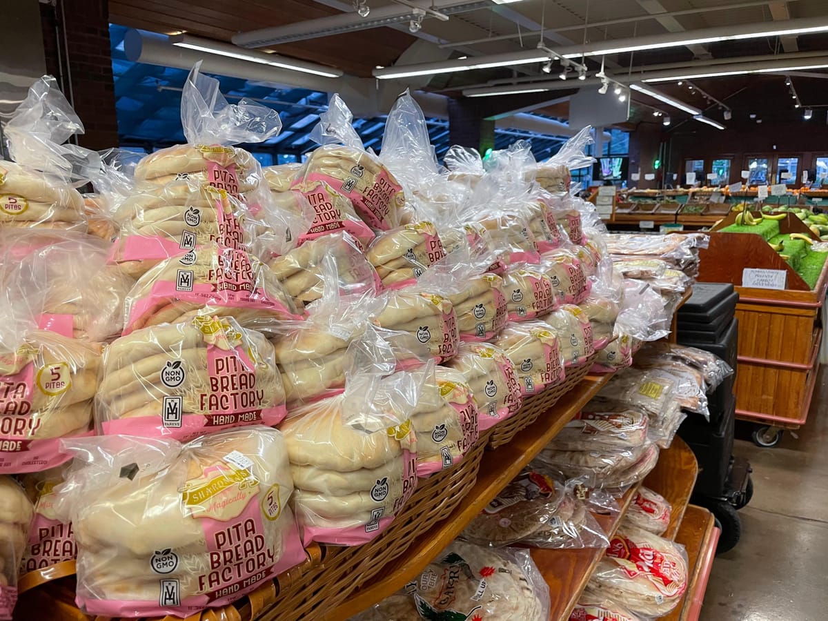Packed grocery store shelf full of Pita Bread Factory packages